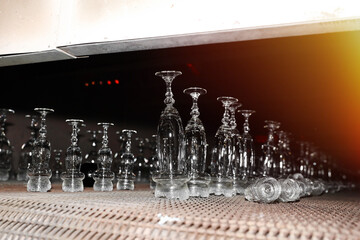 Glass glasses on a conveyor belt. Plant for the production of glass