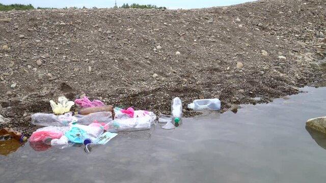 Accumulation of the plastic waste in a shallow of a mountain river, environmental pollution