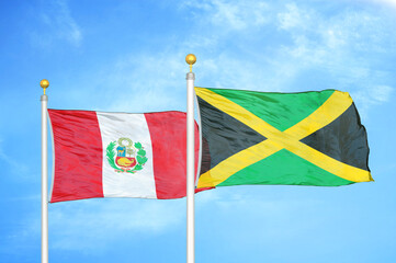 Peru and Jamaica two flags on flagpoles and blue sky