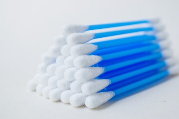 Cotton sticks ear blue plastic on a white background. Personal hygiene and care. Cosmetology and medicine.