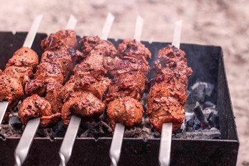 Meat on skewers is cooked on hot coals