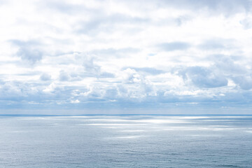 calm blue sea and sun rays penetrating through the clouds in the sky. marine landscape