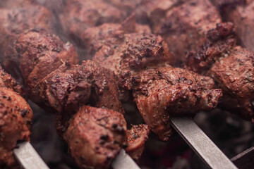 Meat on skewers is cooked on hot coals