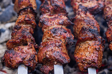 Meat on skewers is cooked on hot coals