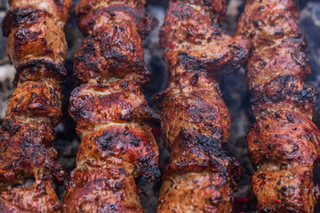 Meat on skewers is cooked on hot coals