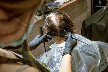 Hairdresser dyes woman hair. Hairdresser colorist dyes the hair of woman. Beautician, hand....