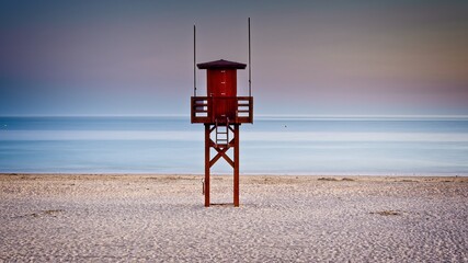 lifeguard tower on beach at sunset