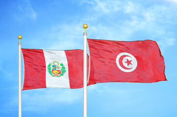 Peru and Tunisia two flags on flagpoles and blue sky