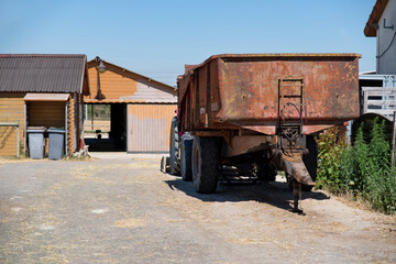 Fototapeta na wymiar Industrial building of a farm with a trailer