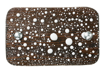 Wooden board with iron bolts in drops of white paint. Isolated