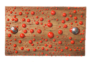 Wooden board with iron bolts in drops of red paint. Isolated