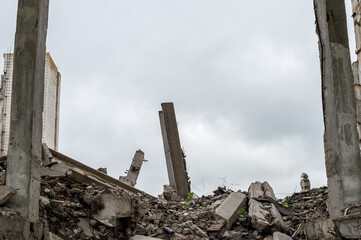 Large grey concrete fragments of a building with a protruding concrete slab against the sky. Background.