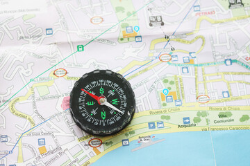 round classic compass on tourist map as symbol of tourism with compass, travel with compass and outdoor activities with compass