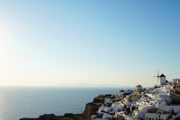 People seeing beautiful sunset from the street of Santorini island, Greece, Europe