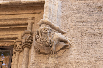 Gothic gargoyle bas relief on an ancient historical building in Valencia