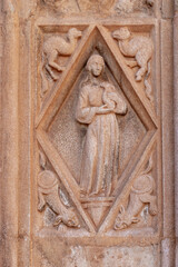 Bas-relief of a woman and animals on Gothic Valencia Cathedral building facade