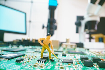 Miniature repair man on mainboard, Miniature figure of worker team try to repair cpu on mainboard.