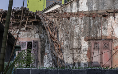 Bangkok,Thailand - Jan 25, 2020 : The remains of a derelict abandoned ancient house with antique...