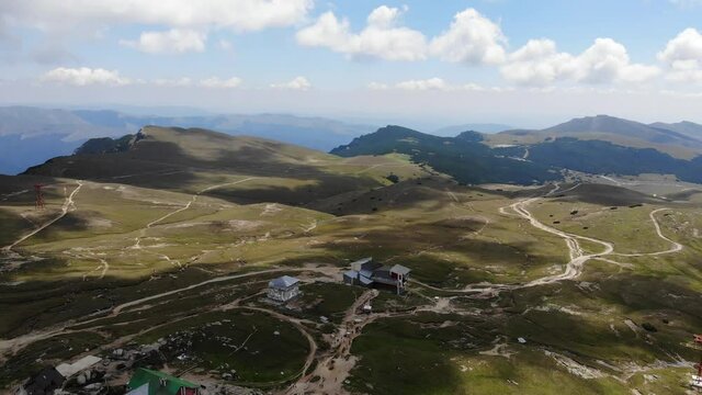 Reverse aerial shot of Babele Cabin and the trail leading to Piatra Arsa