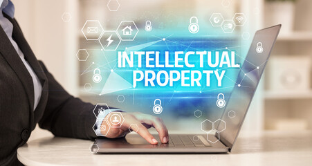 INTELLECTUAL PROPERTY inscription on laptop, internet security and data protection concept, blockchain and cybersecurity
