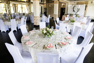 Festive table setting with wine glasses, and fresh flowers