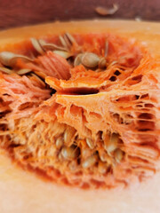 Sliced pumpkin close up with seeds selective focus, blurred background