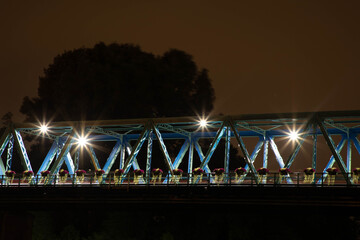 San Dona di Piave e il ponte illuminato di sera con riflesso sul Piave