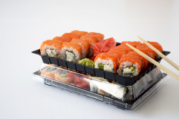 Set of Philadelphia sushi rolls in plastic box. Traditional Japanese food. Delivery service or take away concept.