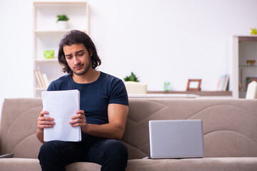 Young man employee working from house