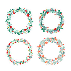 Christmas wreath set with mistletoe, pine, leaves and red flowers