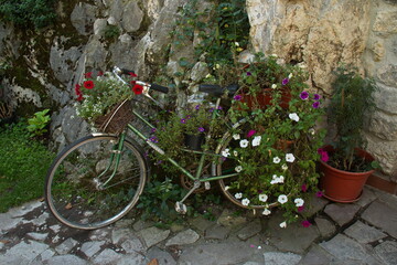 Fototapeta na wymiar Bike with flowers in the village Bulnes in Picos de Europa in Asturias,Spain,Europe 