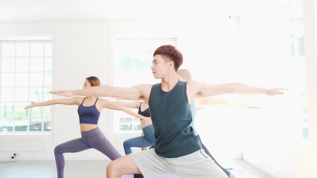 Group of multi ethnic people workout yoga together. 