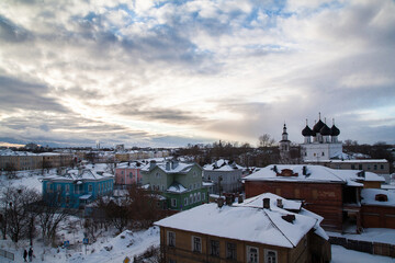 Fototapeta premium Winter ctyscape of small russian town with white orthodox church