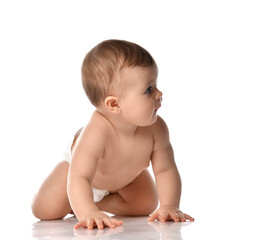 Cute little baby girl infant naked in diaper try to creep on floor looking at the corner isolated on white background