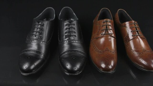 Two pairs of men's classic shoes with laces. Slider shot.