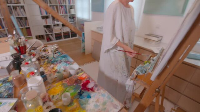 Female painter working on painting in her studio