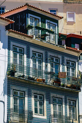 Obraz premium View of classic facade of ancient historical buildings in the downtown area of Lisbon, the hilly coastal capital city of Portugal and one of the oldest cities in Europe 