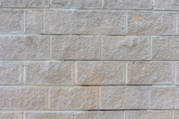 View of old shabby wall made from gray bricks. Abstract textured background. Copy space for your text and decorations.