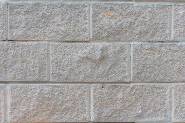 View of old shabby wall made from gray bricks. Abstract textured background. Copy space for your text and decorations.