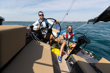 Fototapeta premium two men sailing on a yacht