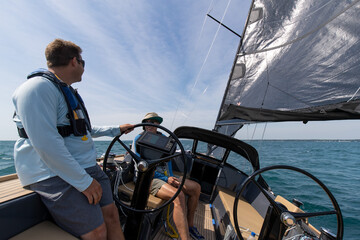 two men sailing on a yacht