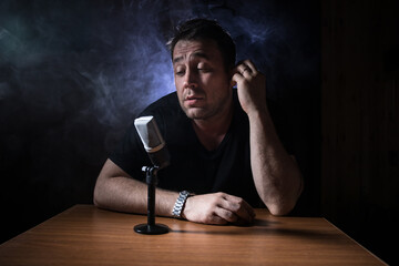 Serious reporter in television studio looking at the camera