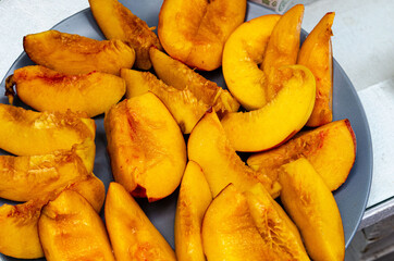 juicy tasty aromatic peach cut into slices and put on a dish