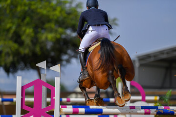 Rider jumps over obstacles during horse show jumping