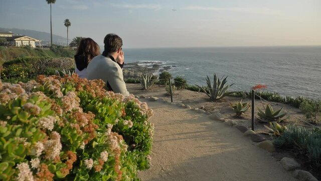 Couple on the bench at Laguna Beach amazing view with beautiful flowers