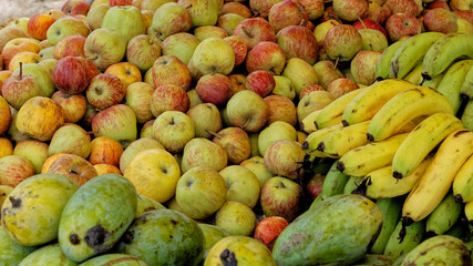 A bunch of healthy fruits on sale by the side of a road