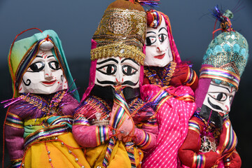 Fototapeta na wymiar Indian handicraft, handmade puppet attached string, King and queen Rajasthan India. Dolls men and women face wearing traditional dress saree, sari, Kurta for plays, Dussehra, Dasara, Diwali festival