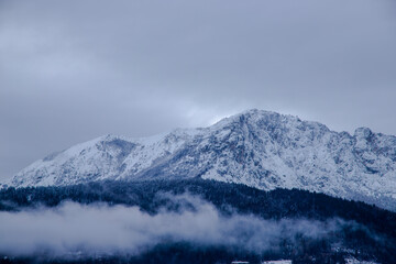 Fototapeta na wymiar snow covered mountains and snow threatens