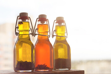 Three bottles of freshly-flavored olive oil with spices.