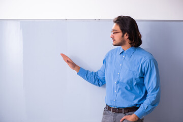 Young male teacher in the classroom